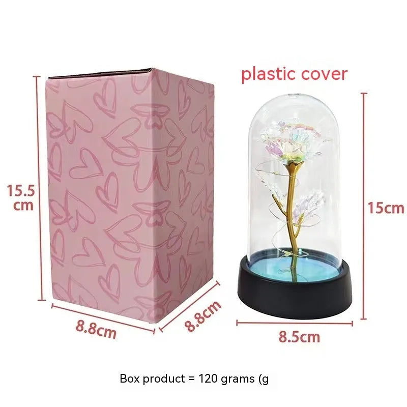 Small decorative night lamp with plastic flower cover and black base, showing coloured light option.