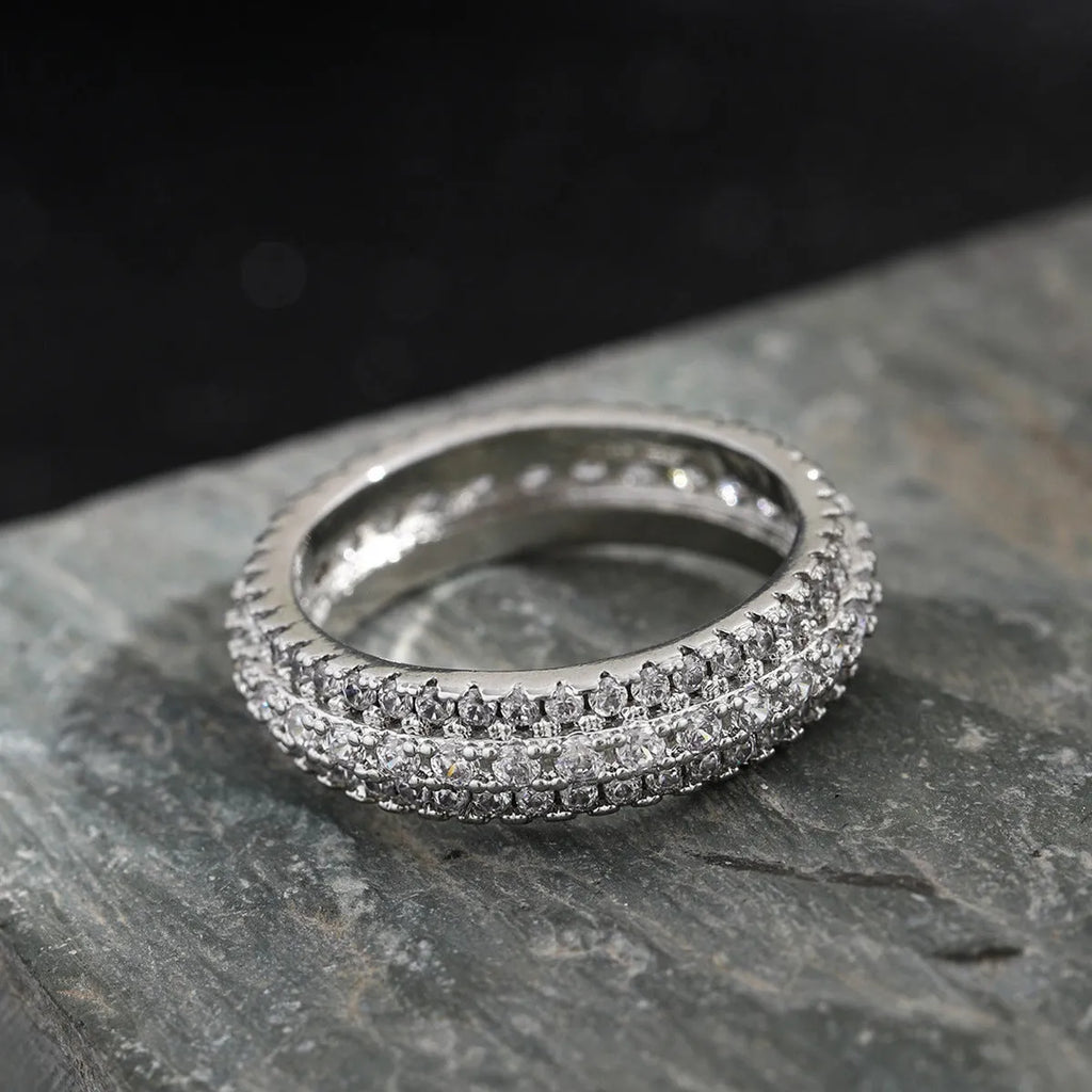 Geometric copper ring with triangular zircon inlay, shown in platinum, yellow gold and white-black finishes.