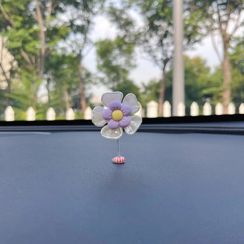 Coloured plastic car decoration swing ornament measuring approximately 5cm by 3.5cm