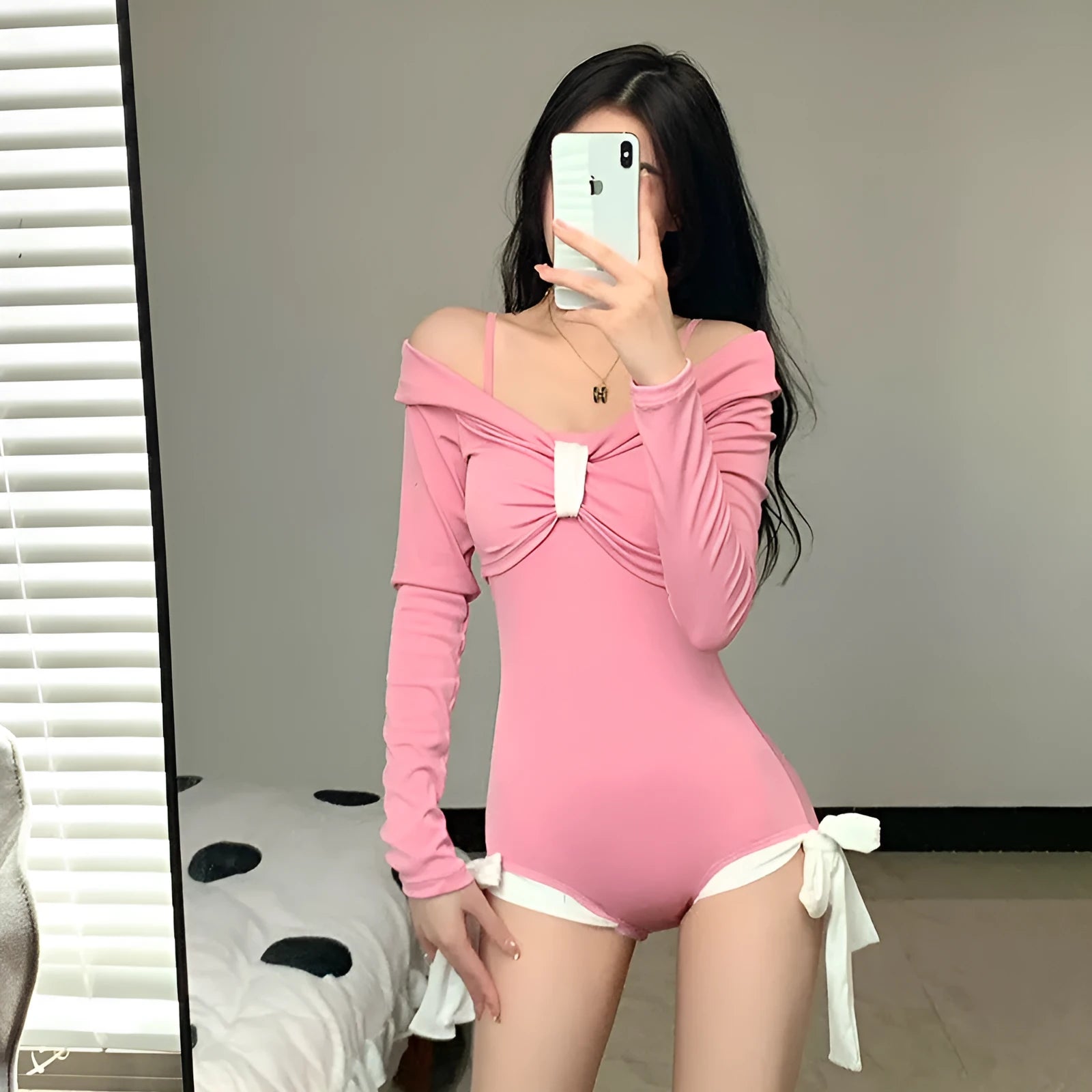 Women's long sleeve one-piece swimsuit in pink on a mannequin.