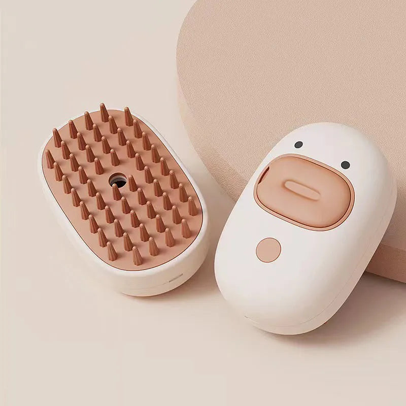 White rechargeable steam pet grooming brush with soft silicone teeth for cats and dogs.