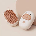 White rechargeable steam pet grooming brush with soft silicone teeth for cats and dogs.