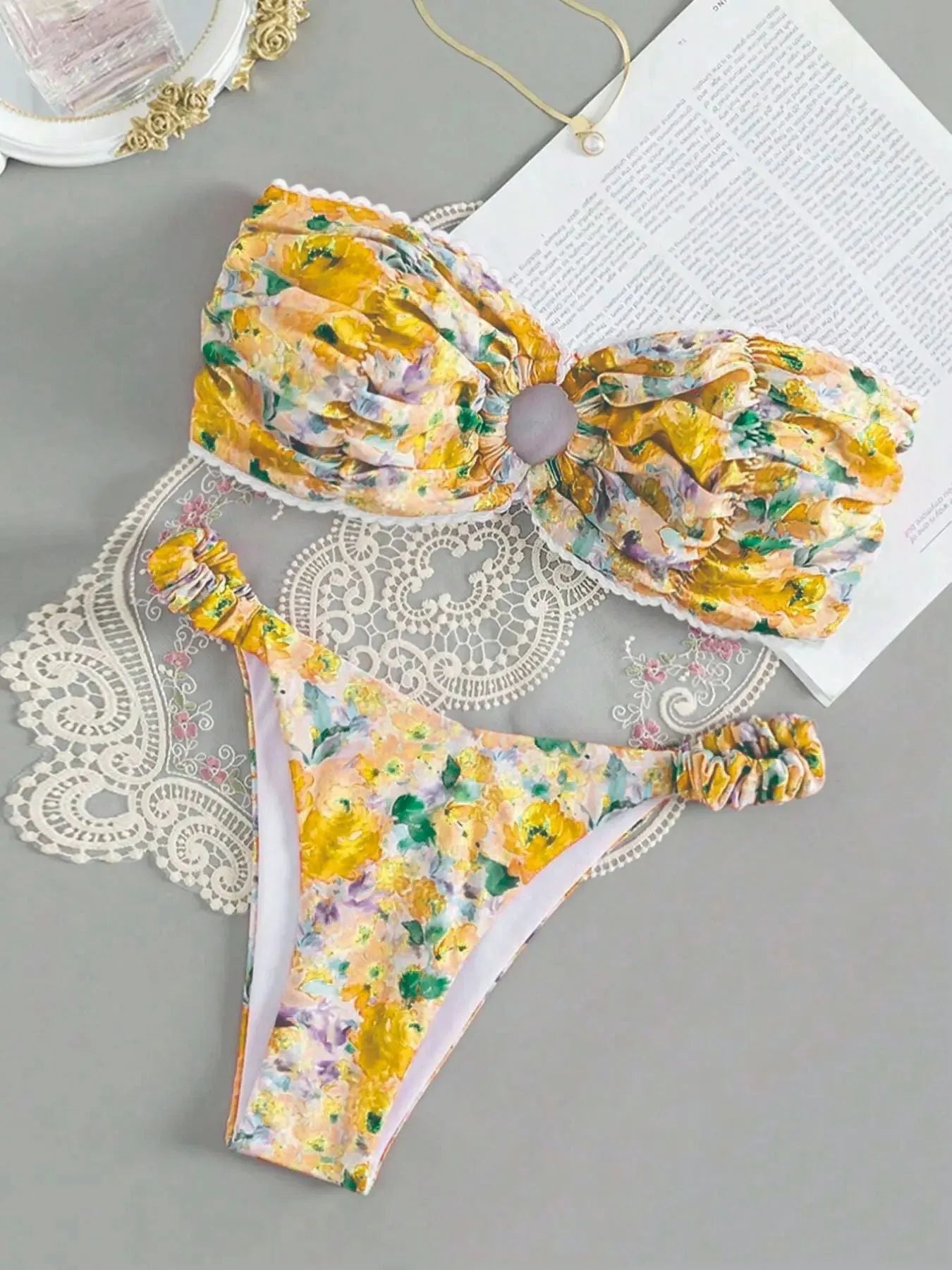 Colourful floral print bikini set with tube top and briefs on a hanger.