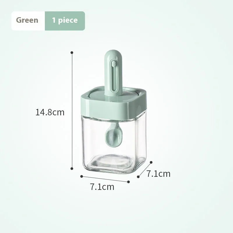Retractable glass seasoning jar in Nordic style with green lid, showing clear glass body and dispensing mechanism