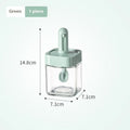 Retractable glass seasoning jar in Nordic style with green lid, showing clear glass body and dispensing mechanism