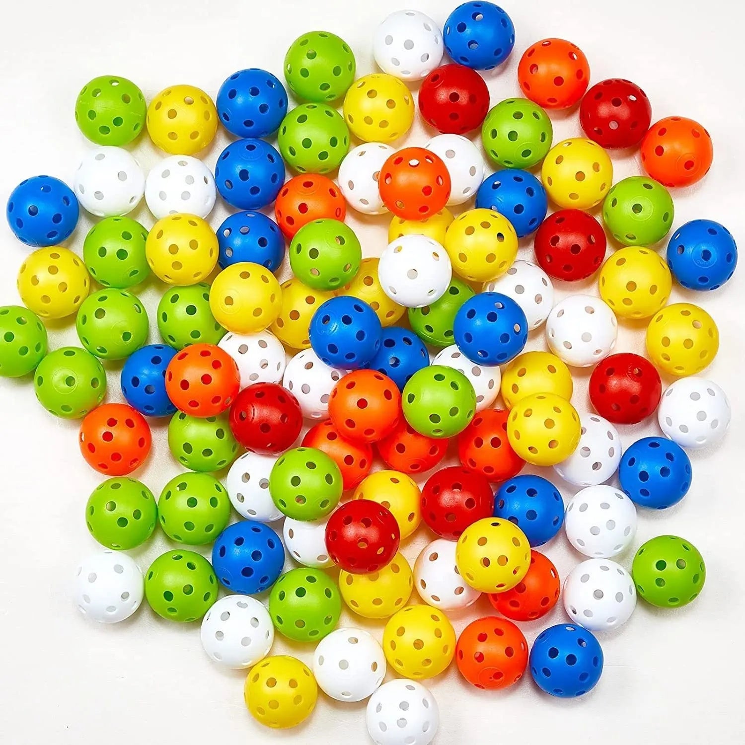 Multi-colour golf practice balls with 26-hole target design on green surface
