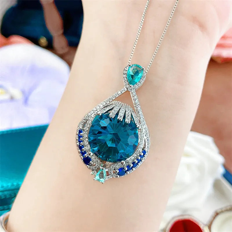 Blue geometric crystal pendant necklace on a silver water wave chain for women