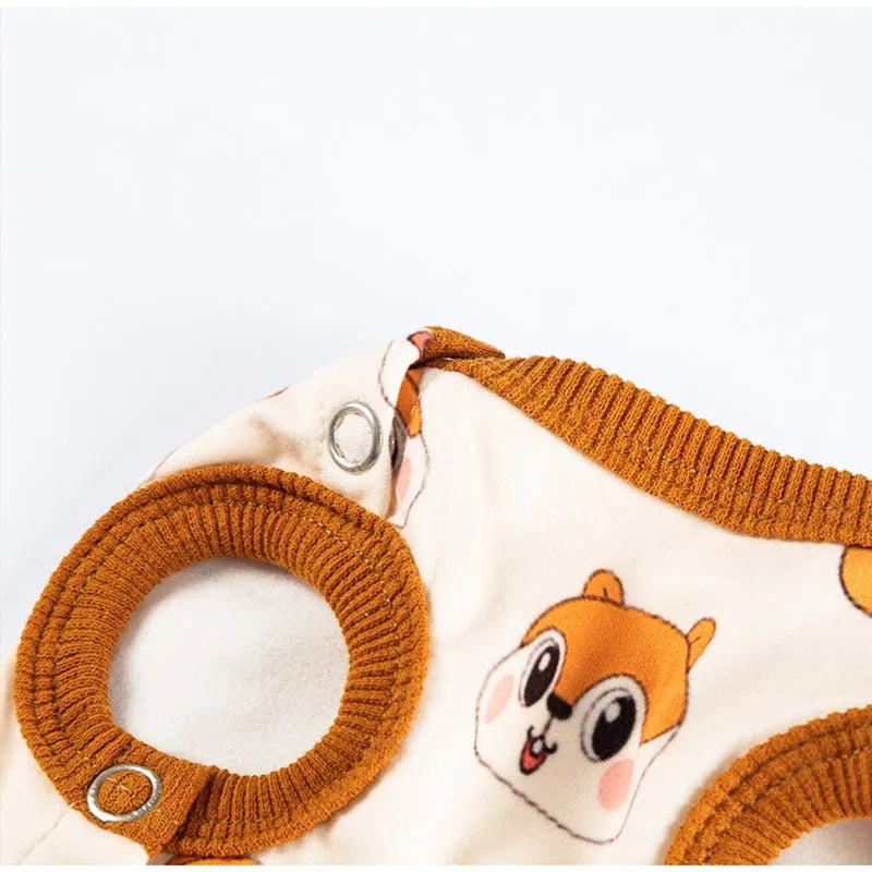Chip 'n' Dale sleeveless dog jumpsuit with squirrel and acorn print, fuzzy embroidered acorn pocket, ribbed cuffs and snap closure, cream or white.