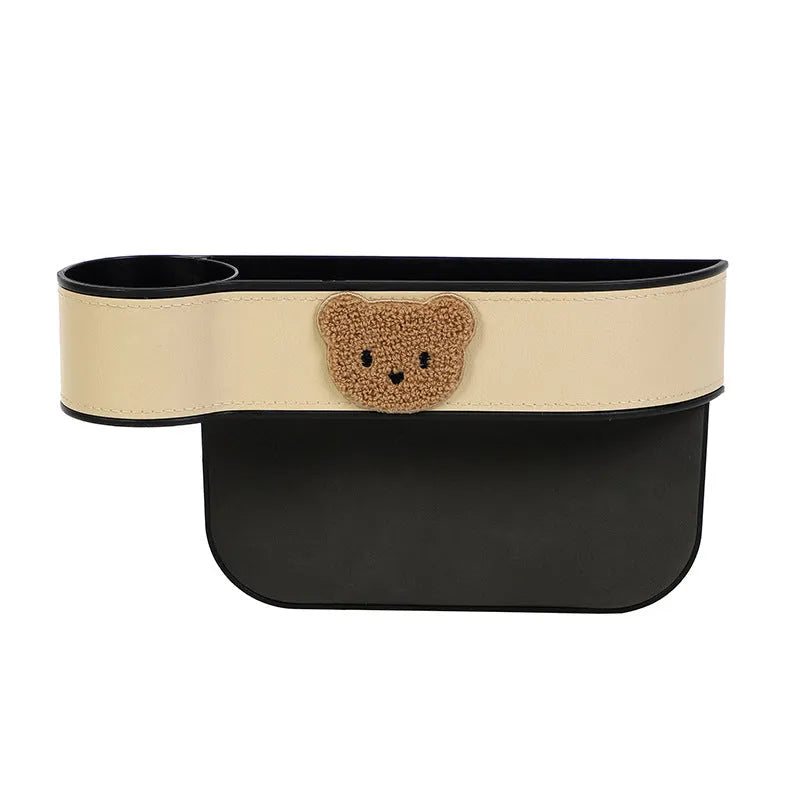 Leather car seat gap storage box with cartoon bear design, shown fitted next to a car seat.
