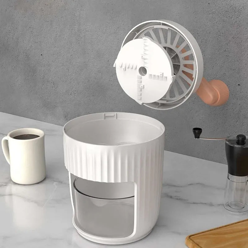 Hand-cranked ice shaving machine in green and orange, with removable ice box and ergonomic handle