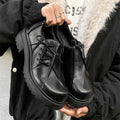 Black platform leather shoes with warped head design and round toe cap