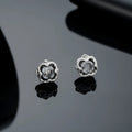 Titanium steel clip-on earrings with geometric star design in black colour, unisex style