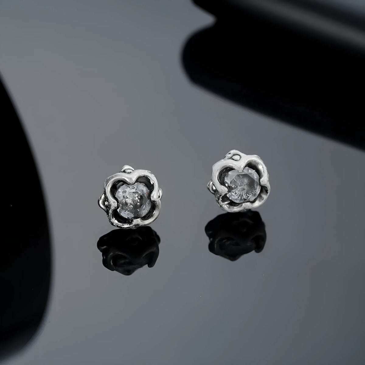 Titanium steel clip-on earrings with geometric star design in black colour, unisex style