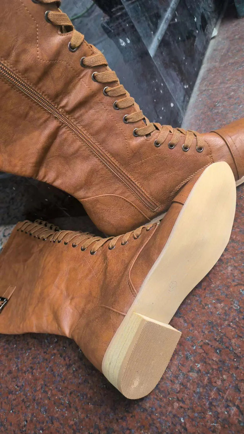Women's black knight ankle boots with a cross strap over the instep, made from artificial PU.