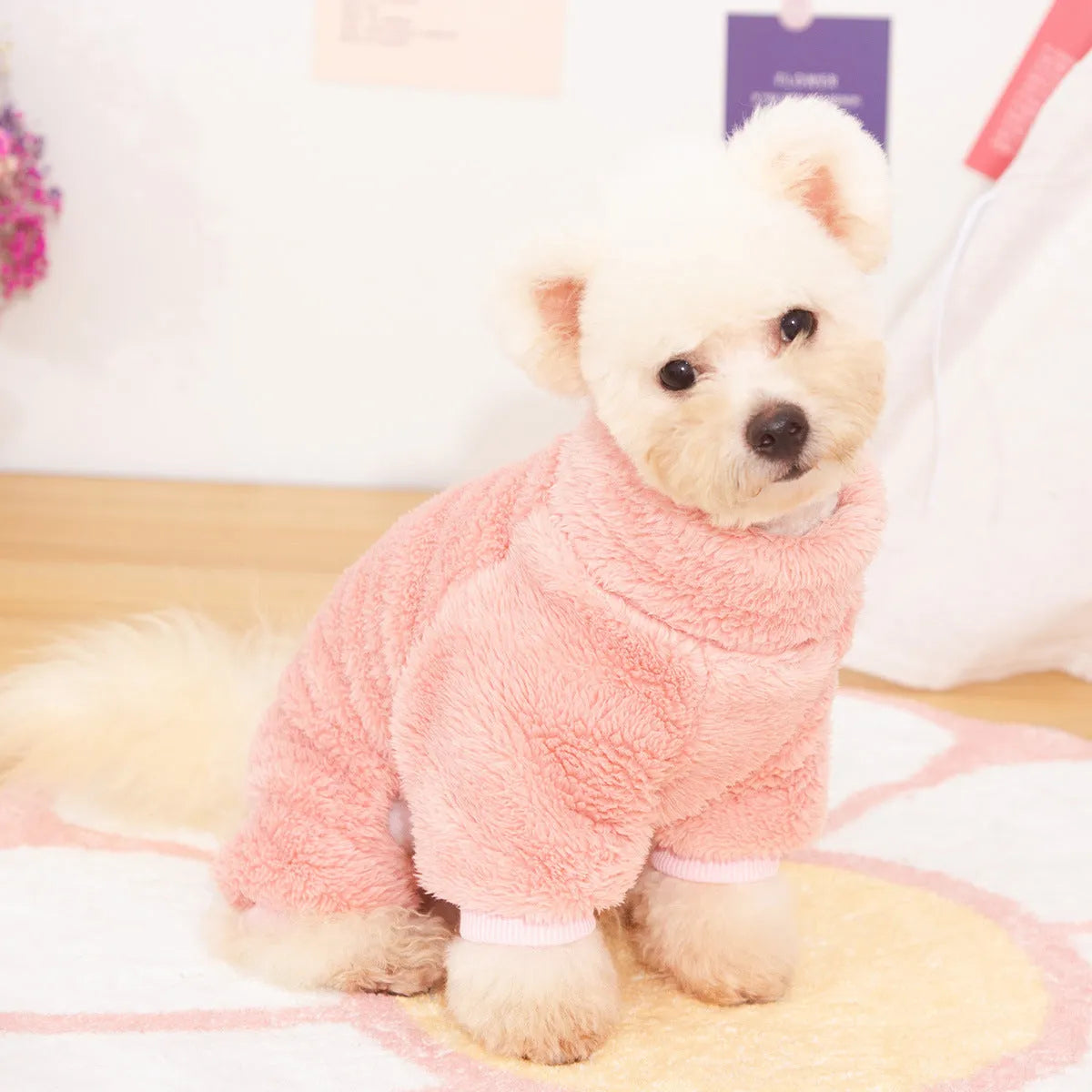 Four-legged dog clothes in blue with high collar and towing ring, showing plush material and full-body coverage