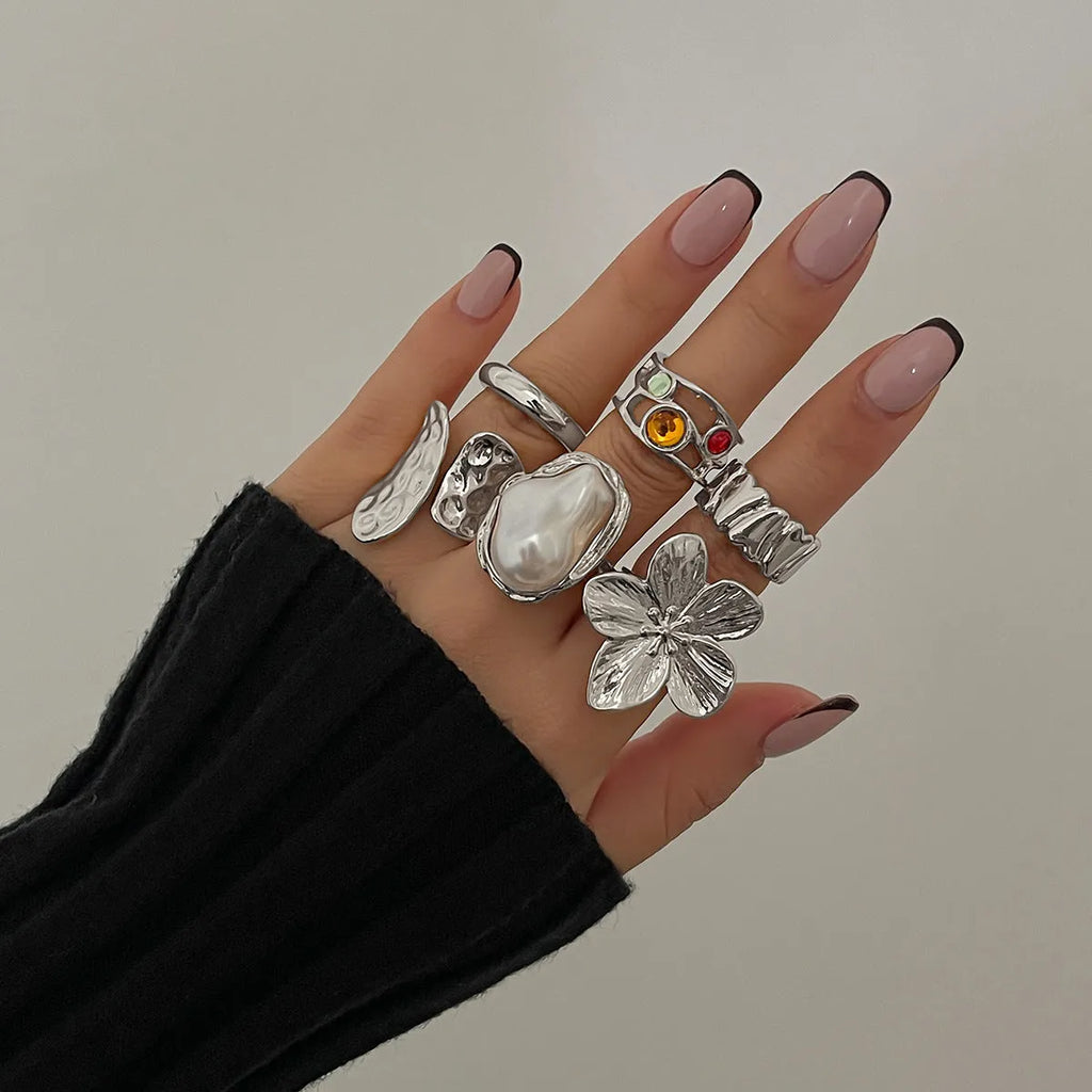Women's open ring with liquid lava flower design, imitation pearl detail, available in gold or silver