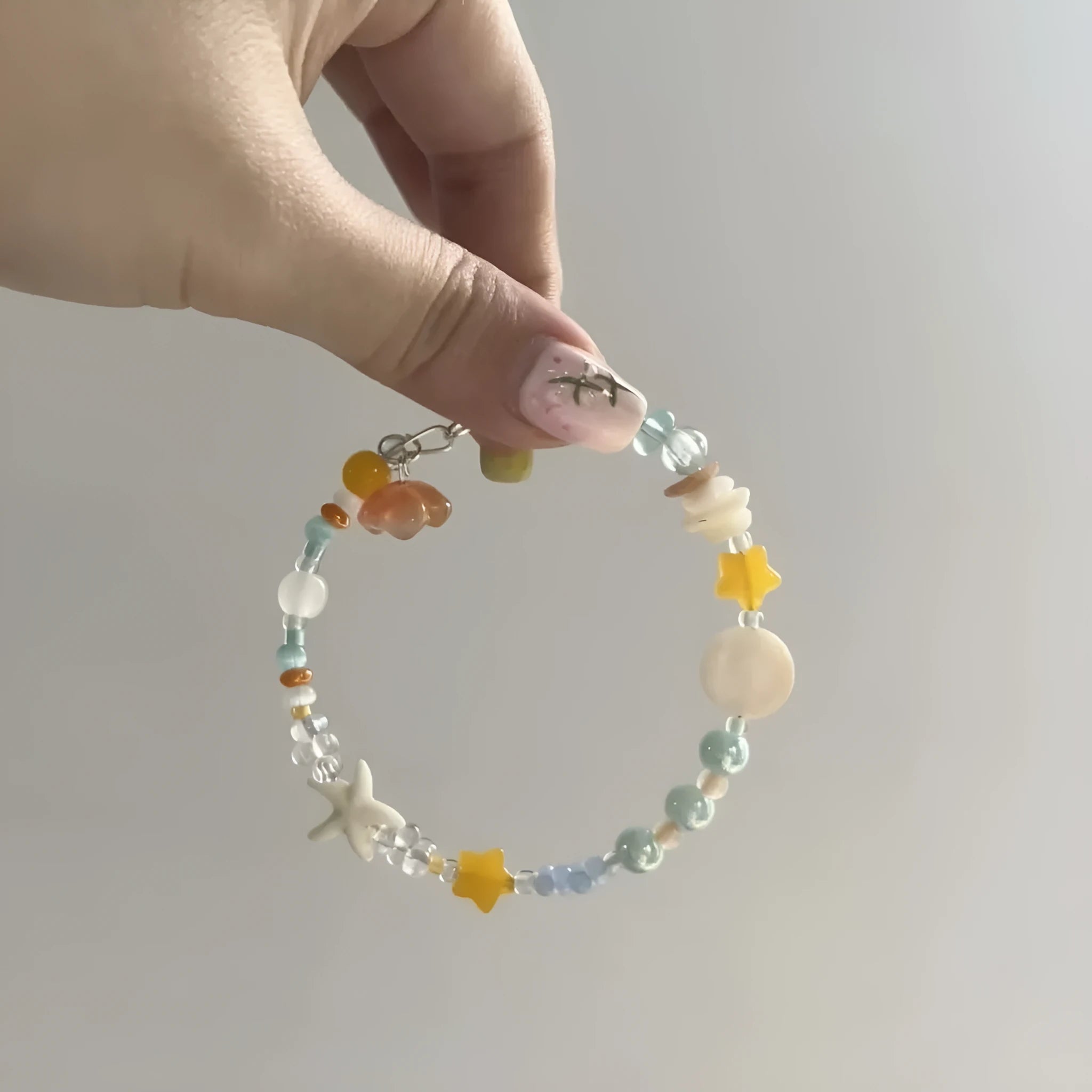 Orange sea coloured alloy bracelet with diamond shape and round element design for women