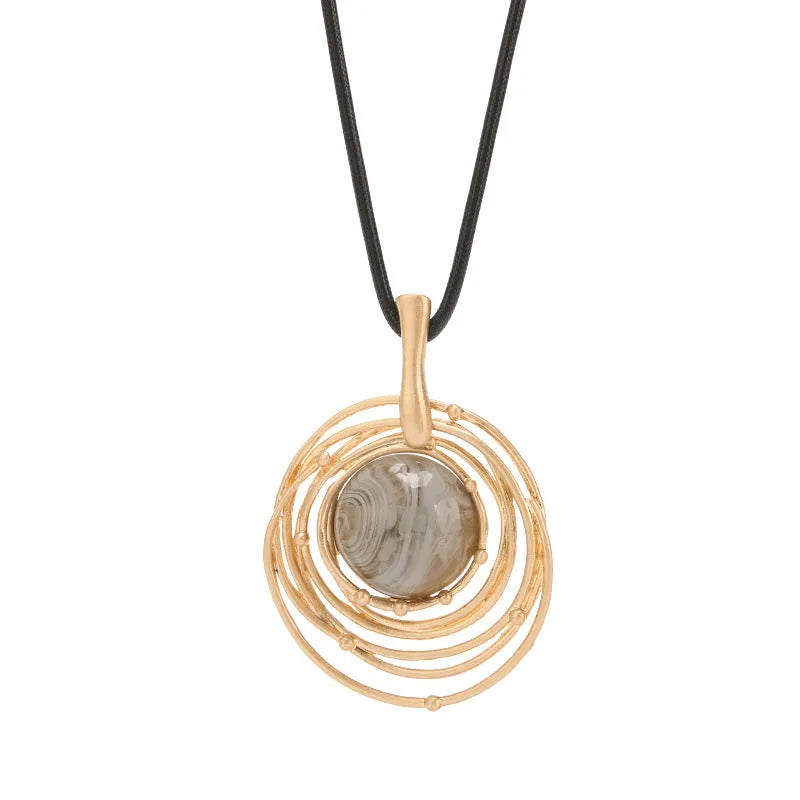 Gold geometric pendant sweater chain necklace with snakeskin texture rope on model