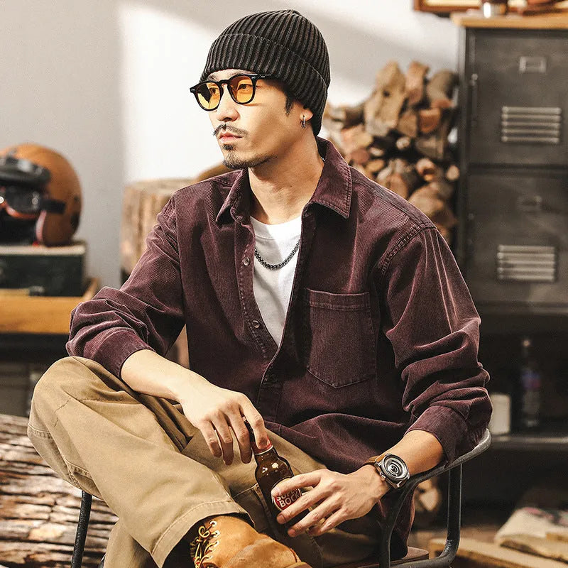 Men's loose-fit long-sleeved corduroy shirt jacket in black or red, showing textured combed cotton fabric.