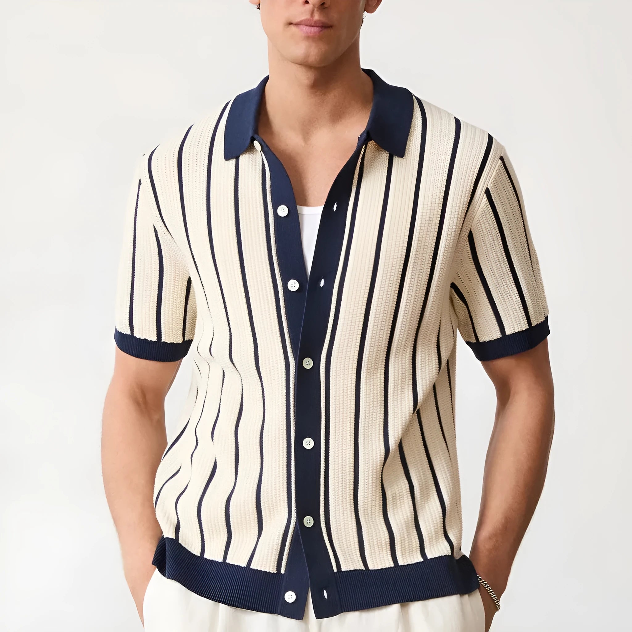 Men's white asymmetrical short sleeve knitted top with a lapel collar, shown on a model.
