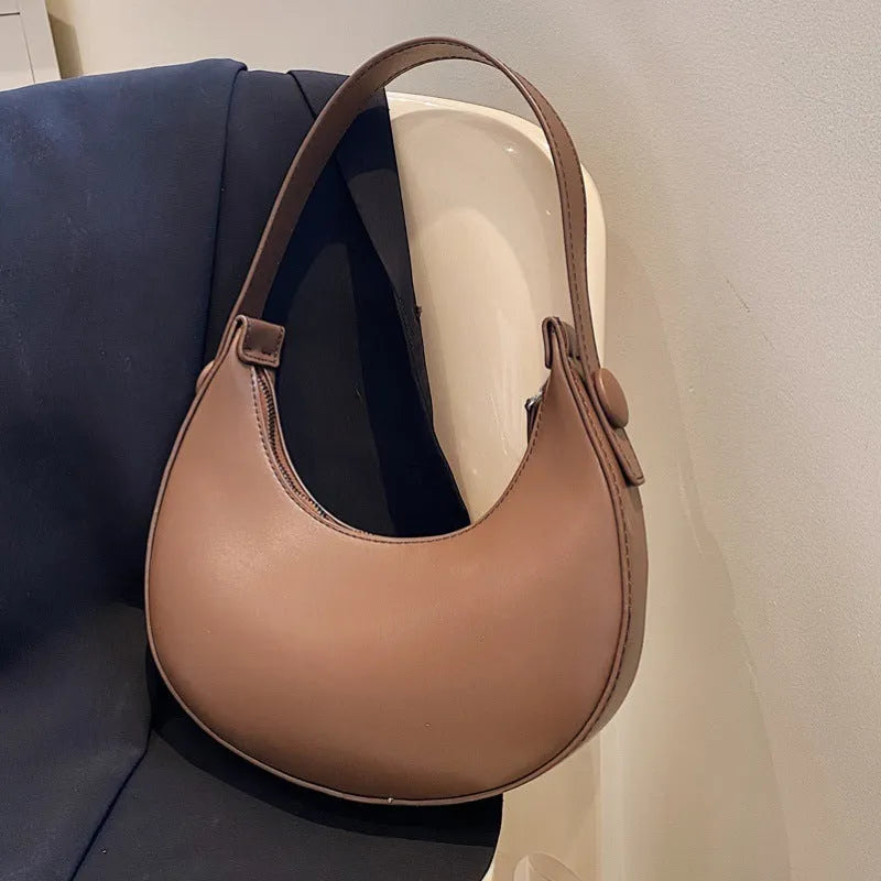 Retro dumpling shape shoulder bag in PU leather showing dimensions 21x20x6cm with zipper change bag interior