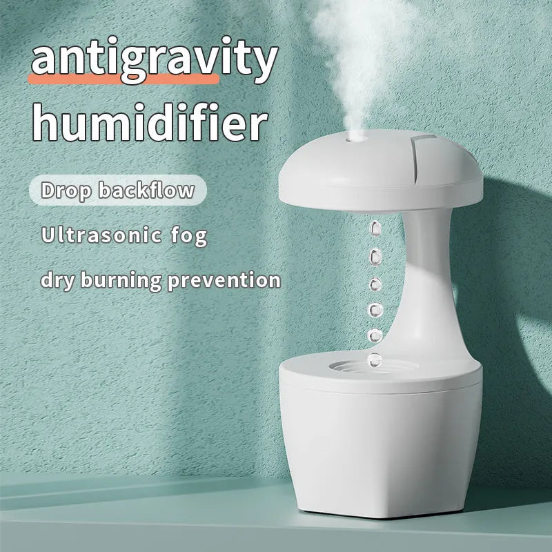 White portable 800ml anti gravity USB cool mist aromatherapy humidifier on a bedside table with water droplet effect visible