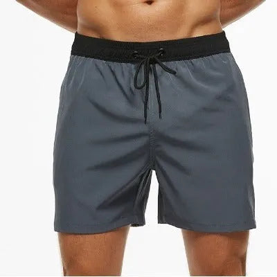 Men's blue athletic shorts with a drawstring waist, zipper pockets, and visible stitching detail.