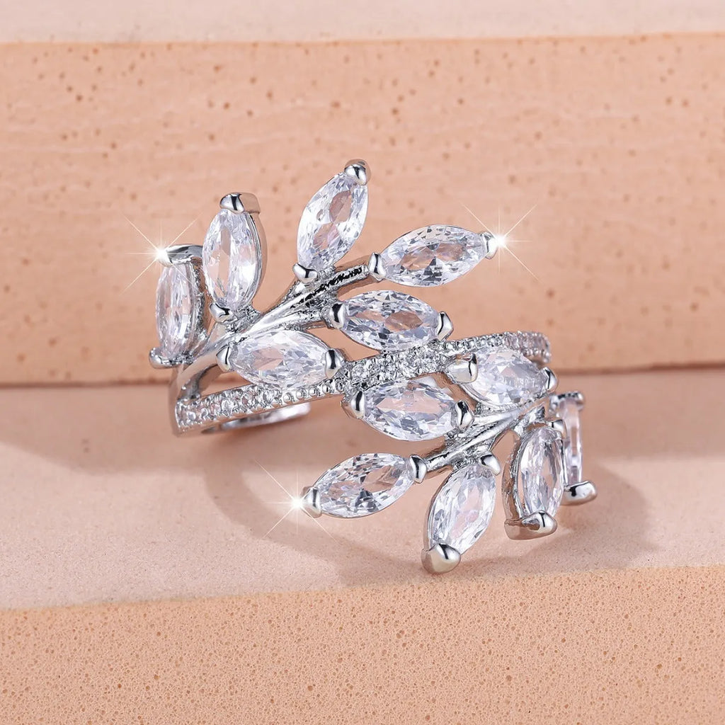Adjustable leaf ring with horse eye zircon stone in rose gold finish on wooden background