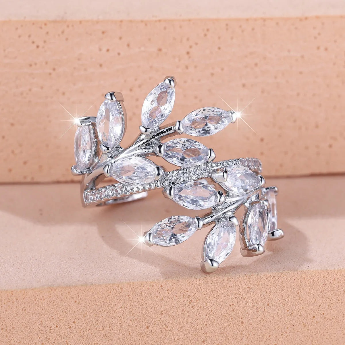 Adjustable leaf ring with horse eye zircon stone in rose gold finish on wooden background