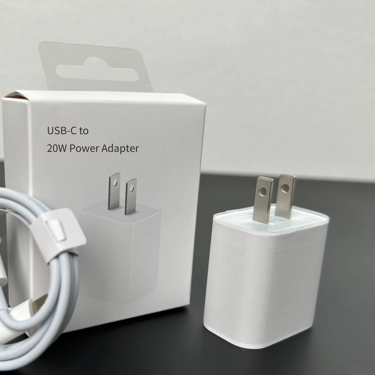 White 20W USB-C PD wall charger with UK three-pin plug.