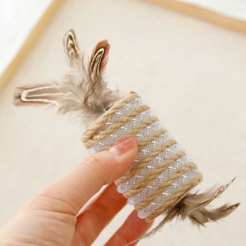 Beige interactive cat feather wand toy with hemp rope scratching surface and a catnip ball.