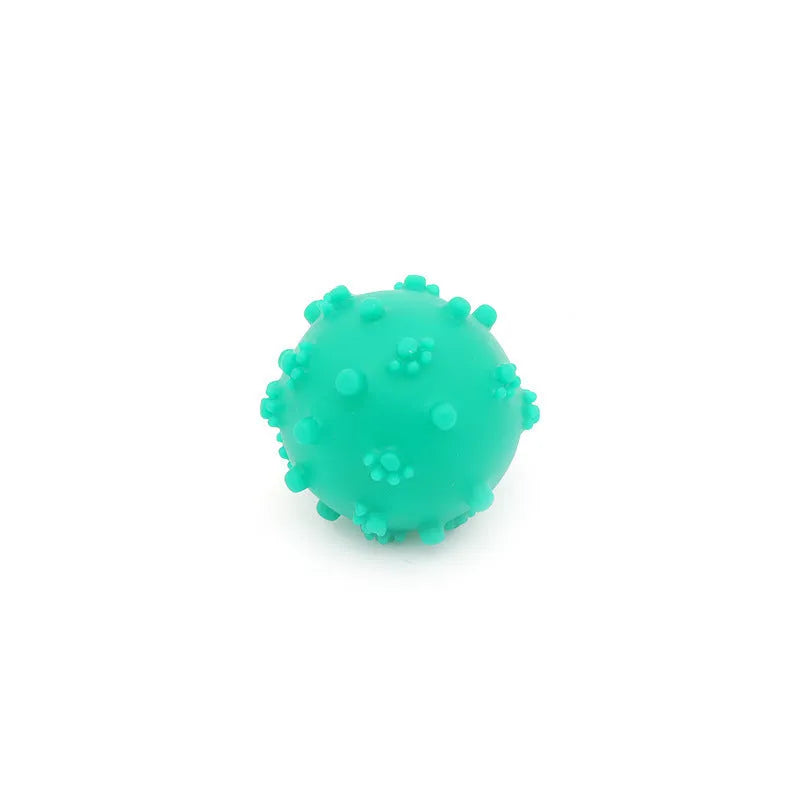 Four brightly coloured spiky dog toy balls with paw-print dimples, shown next to a small dog.