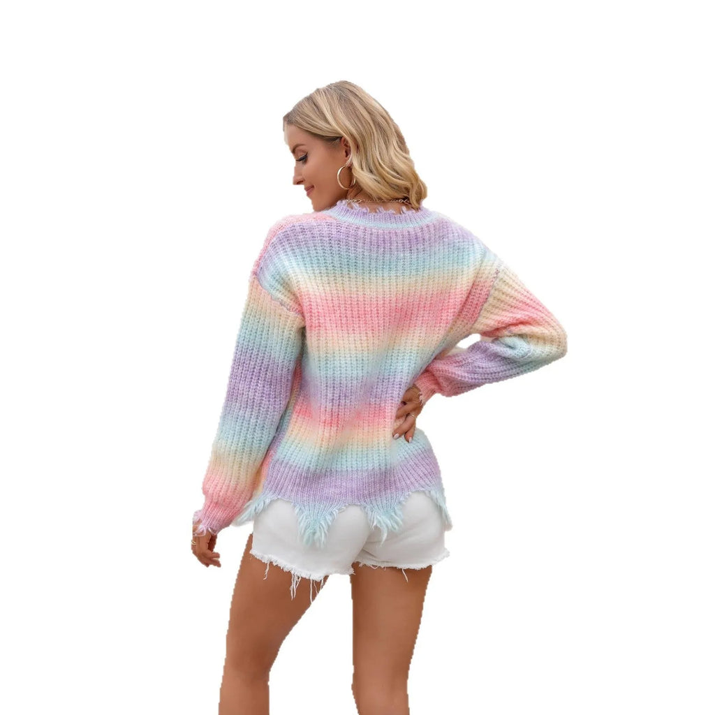 Pink rainbow gradient loose-cut knitted pullover sweater with tassels on a hanger.