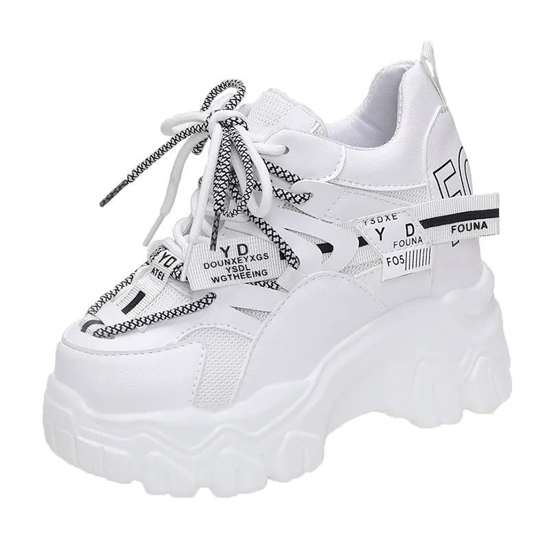 Women's white and black mesh platform sports shoes with cross strap and rubber sole.