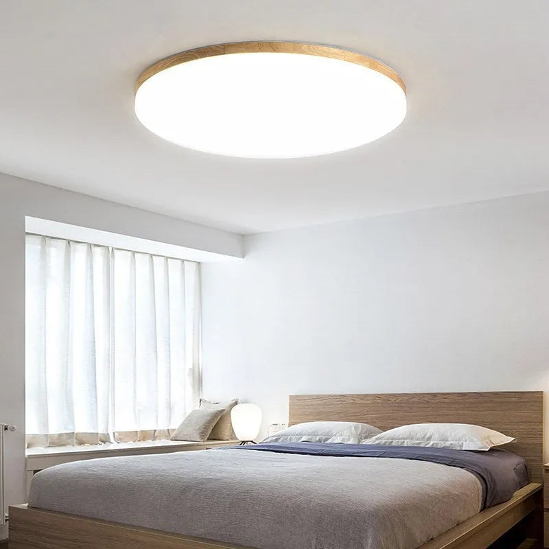 Japanese minimalist ceiling lamp with a wood art body and white acrylic shade in three available diameters.