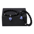 Matching natural stone couple bracelets with geometric heart shape in polished obsidian.
