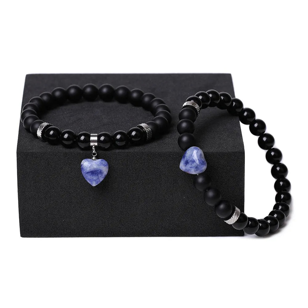 Matching natural stone couple bracelets with geometric heart shape in polished obsidian.
