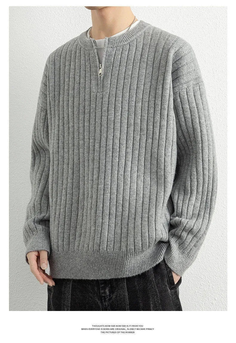 Men's loose grey half zipper textured knit sweater on a hanger.