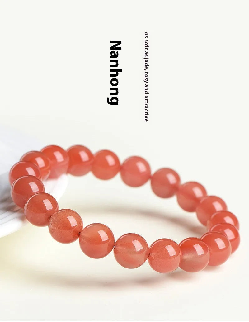 Natural cherry red agate beaded bracelet with polished round stones on a string.