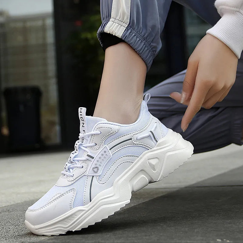 Women's white mesh casual trainers with a thick sole, round toe, and a buckle fastening detail.