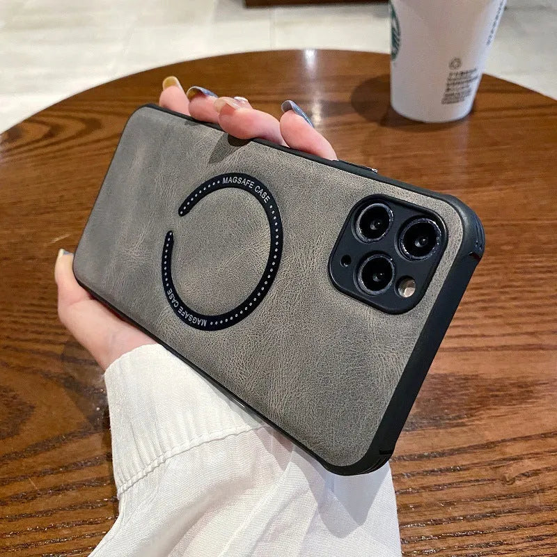 Black imitation leather magnetic charging case for Apple iPhone on a table.