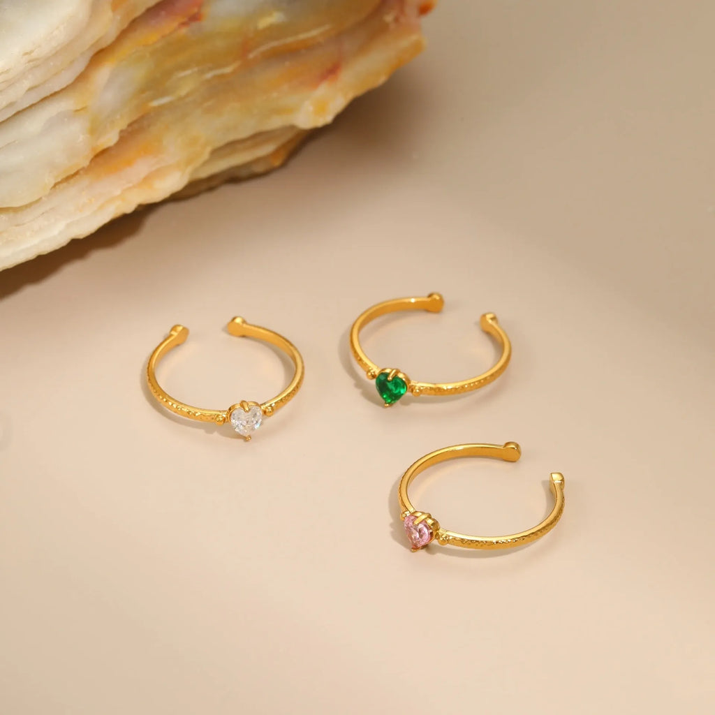 Open-ended stainless steel heart-shaped ring with inlaid zircon stones in green, pink, or white.