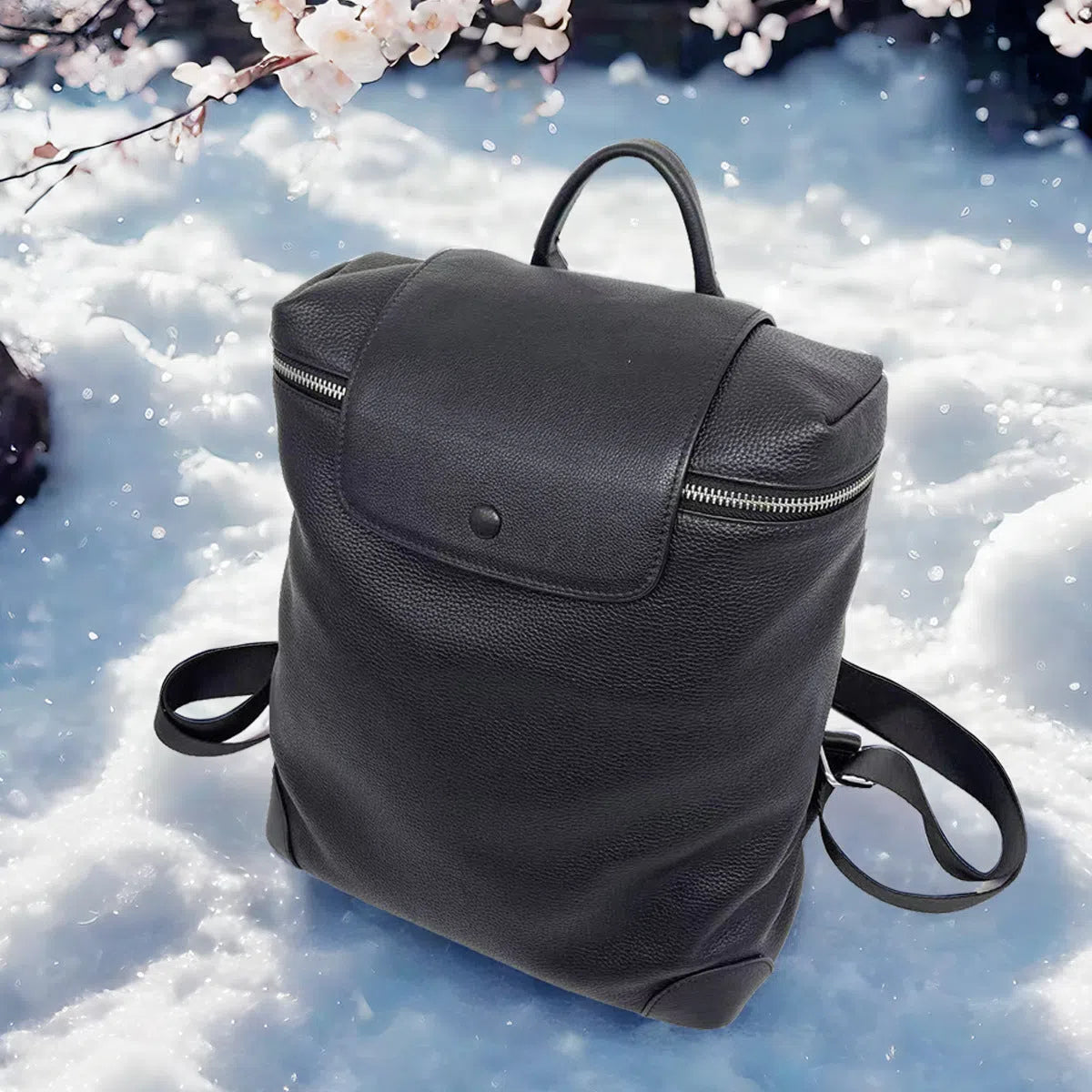 Black full-grain leather backpack, 30 x 13 x 35 cm, with curved shoulder straps and patchwork front
