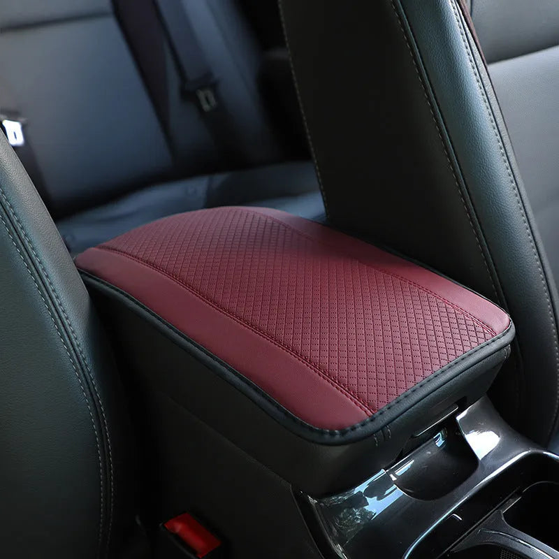 Automotive fibre leather embossed armrest box mat measuring 32x19cm in black with red cord detailing