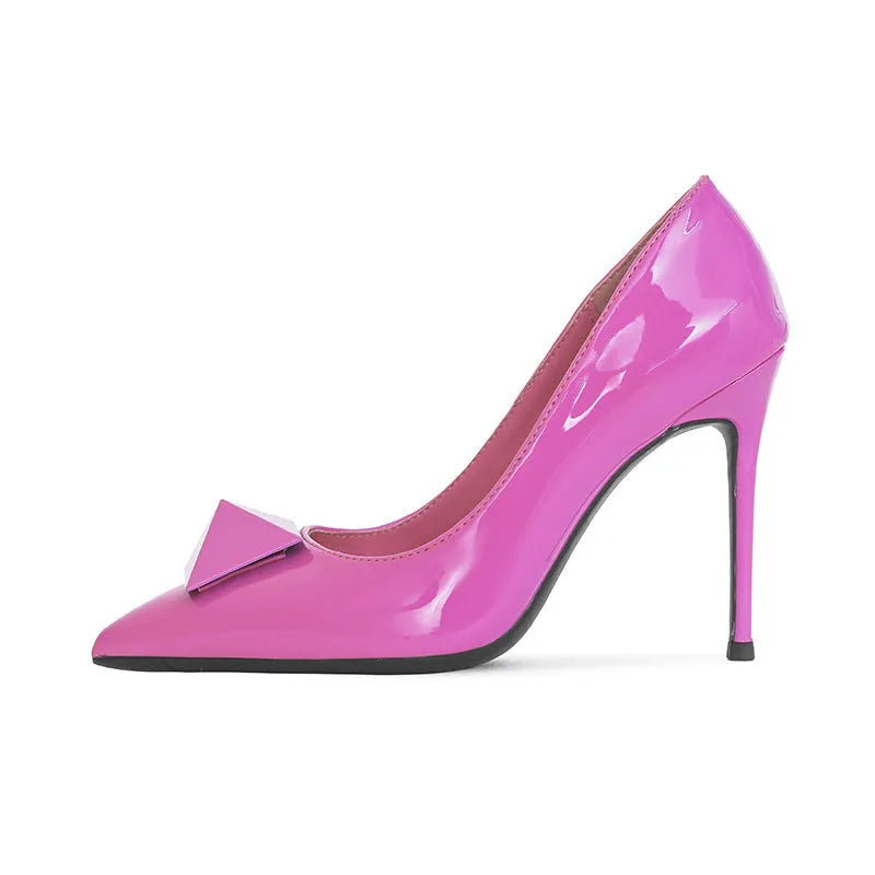 Pink patent leather women's high heels with pointed toe, stiletto heel, and buckle detail on a low-top design.