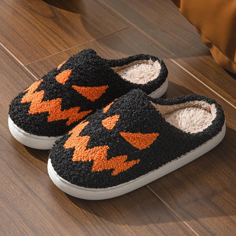 Halloween couple slippers with black and orange ghost face embroidery on suede upper and PVC sole.