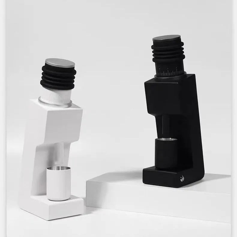 Electric coffee grinder with inclined aluminium alloy body in white on a countertop for home or office use