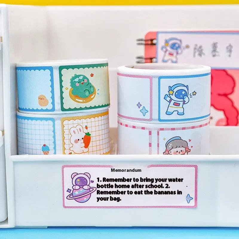 Roll of cartoon name stickers showing dinosaur, astronaut, rabbit, and girl designs.
