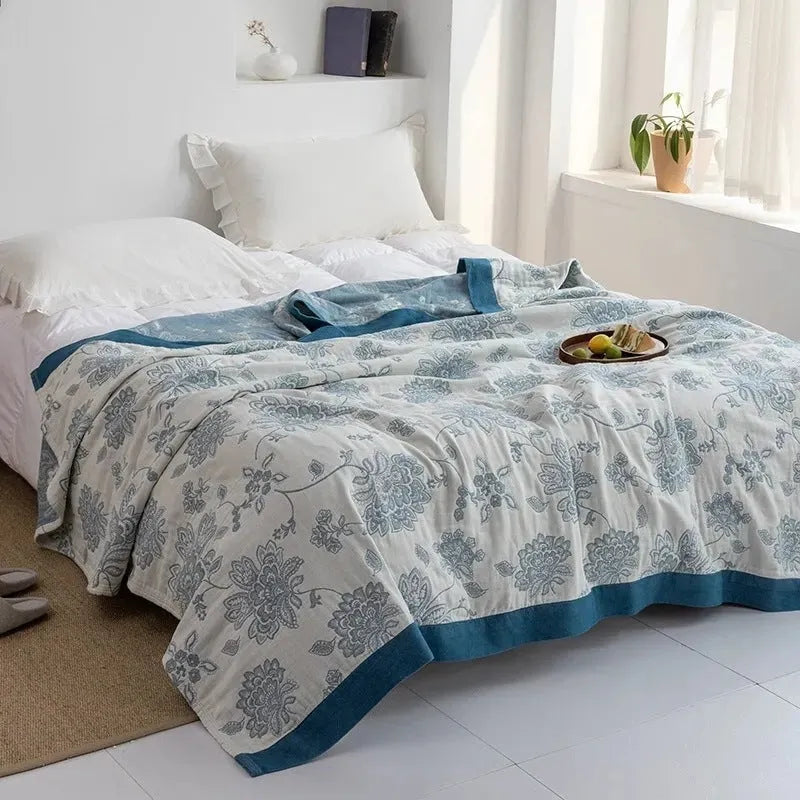 Pure cotton five-layer gauze towel blanket in Roulette Wheel Blue, shown on a bed.