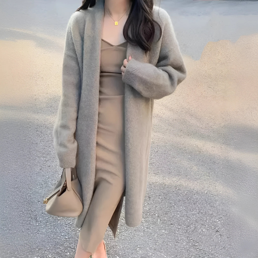 Women's loose fit grey knitted cardigan with V-neck and long sleeves, mid-length style.